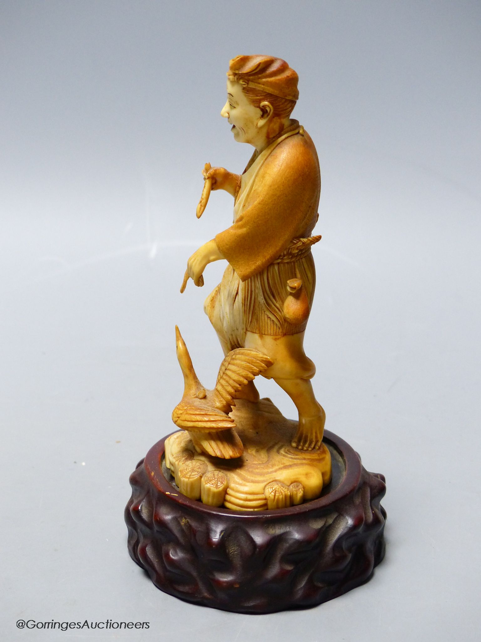 A Japanese ivory figure of a cormorant fisherman, early 20th century